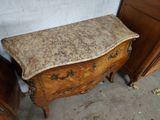 a small wooden chest of drawers with a marble top