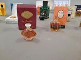 bottles of perfume sitting on a table next to a box of perfume