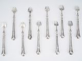 a lot of spoons and forks on the table