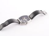 an image of a watch on a white surface with a black strap