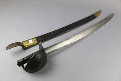 pair of two swords on a white surface with a black handle