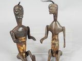 pair of wooden figurines of a man and a woman