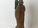 two statues of people standing next to each other on a white surface