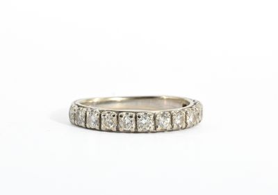 a close up of a diamond ring on a white surface
