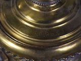 a close up of a brass lamp on a table