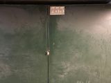 two green doors that are open in a building