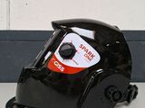 a black helmet with a sticker on it sitting on a table