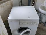 a washer and a toilet in a bathroom