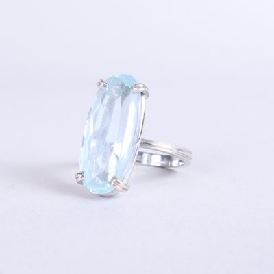 a close up of a ring with a blue topaz stone