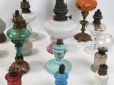 a lot of different colored glass vases on the table