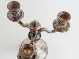 a silver candelab with three candles on it
