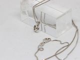 a small box with a chain and a necklace on it
