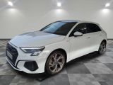 a white audi q3 parked on a checkered tile floor