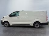 the white van is parked on the concrete floor in the room