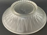 a clear glass bowl with a lid on a black table