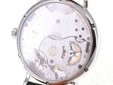 a close up of a watch on a white surface