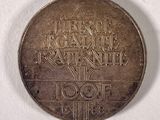 a silver coin with a picture of a man on it
