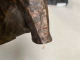 a statue of a bull that is on display in a museum