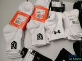 several pairs of white socks sitting on top of a white table