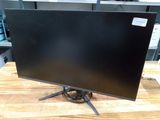 a computer monitor sitting on top of a wooden table