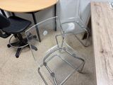 two chairs and a table in the corner of a room