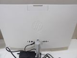 a computer monitor with a power cord plugged into it
