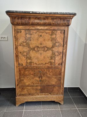 a wooden cabinet with a marble top in a bathroom