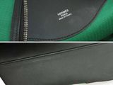 a picture of a black and green purse with a zipper