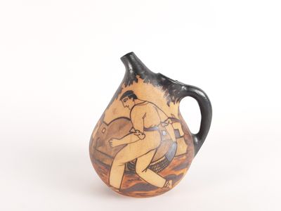a vase with a painting on it on a white surface