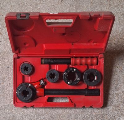 an image of a red tool box with tools inside of it