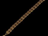 a close up of a gold chain bracelet on a black background