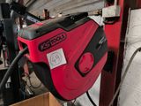 an image of a red and black air compressor in a garage
