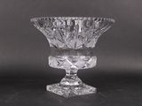 a clear glass vase on a table with a black background