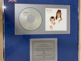a framed picture of a woman and a cd in a blue frame