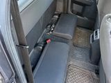 the interior of a car with the door open and the passenger seat down