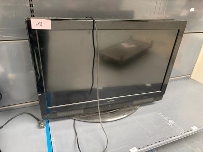 un téléviseur à écran plat posé sur une étagère dans un magasin
