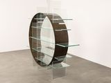 a glass shelf with a mirror on it in a room