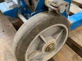 a dolly with a wheel attached to it on a pallet