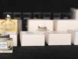 a small bottle of perfume sitting next to a box of soap