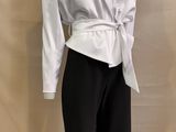 a picture of a white shirt and black pants on a mannequin mannequin