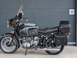 a black motorcycle parked in front of a garage door