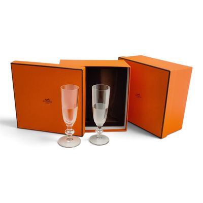 an orange box containing two champagne glasses and a wine glass