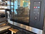 a microwave that is sitting on a shelf in a kitchen