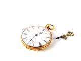 a gold pocket watch with a key attached to it