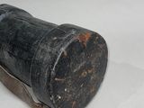 a black object that is sitting on a white surface