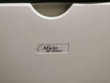 a close up of a white printer with a black handle