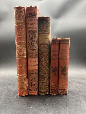 several old books are stacked on top of each other on a table