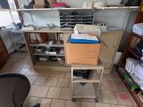 a room with a desk, shelves, and a chair in it