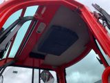 a red truck with a mirror on the side of it