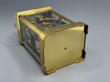 a gold clock that is sitting on top of a table